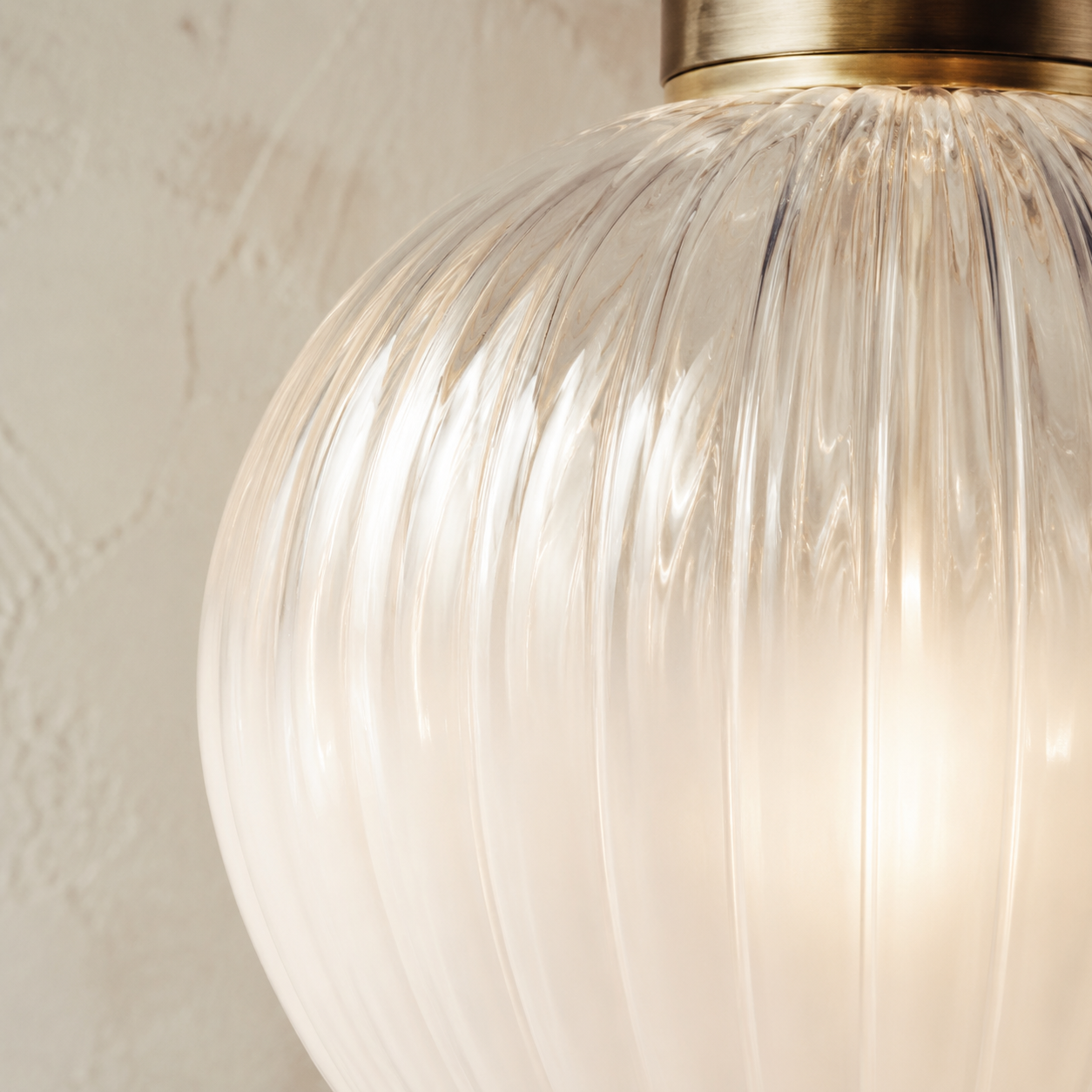 Hand-blown ribbed glass globe with a gentle warm light