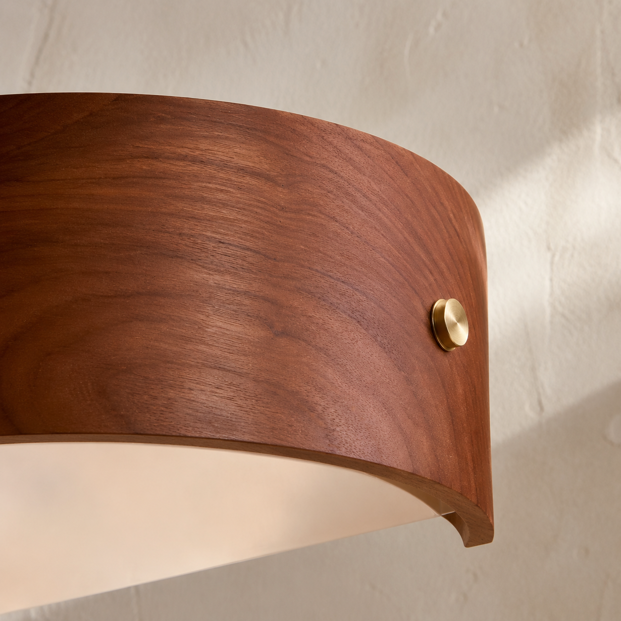 Cherry wood lighting detail with brushed brass fitting