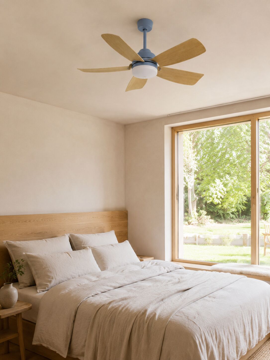 Blue-gray five-blade ceiling fan above a warm minimal bedroom