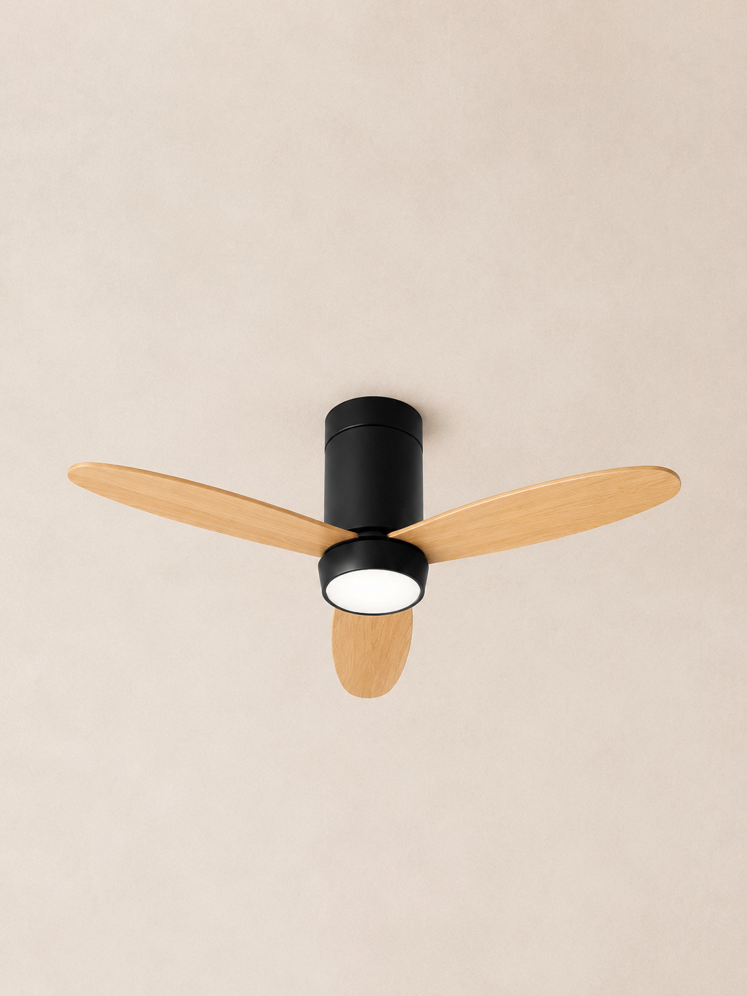 Wooden Color black flush mount ceiling fan centered on pale ivory