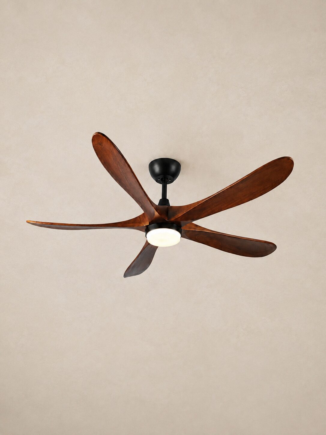 62-inch Walnut Color five-blade ceiling fan with integrated LED centered on a pale limewash ceiling