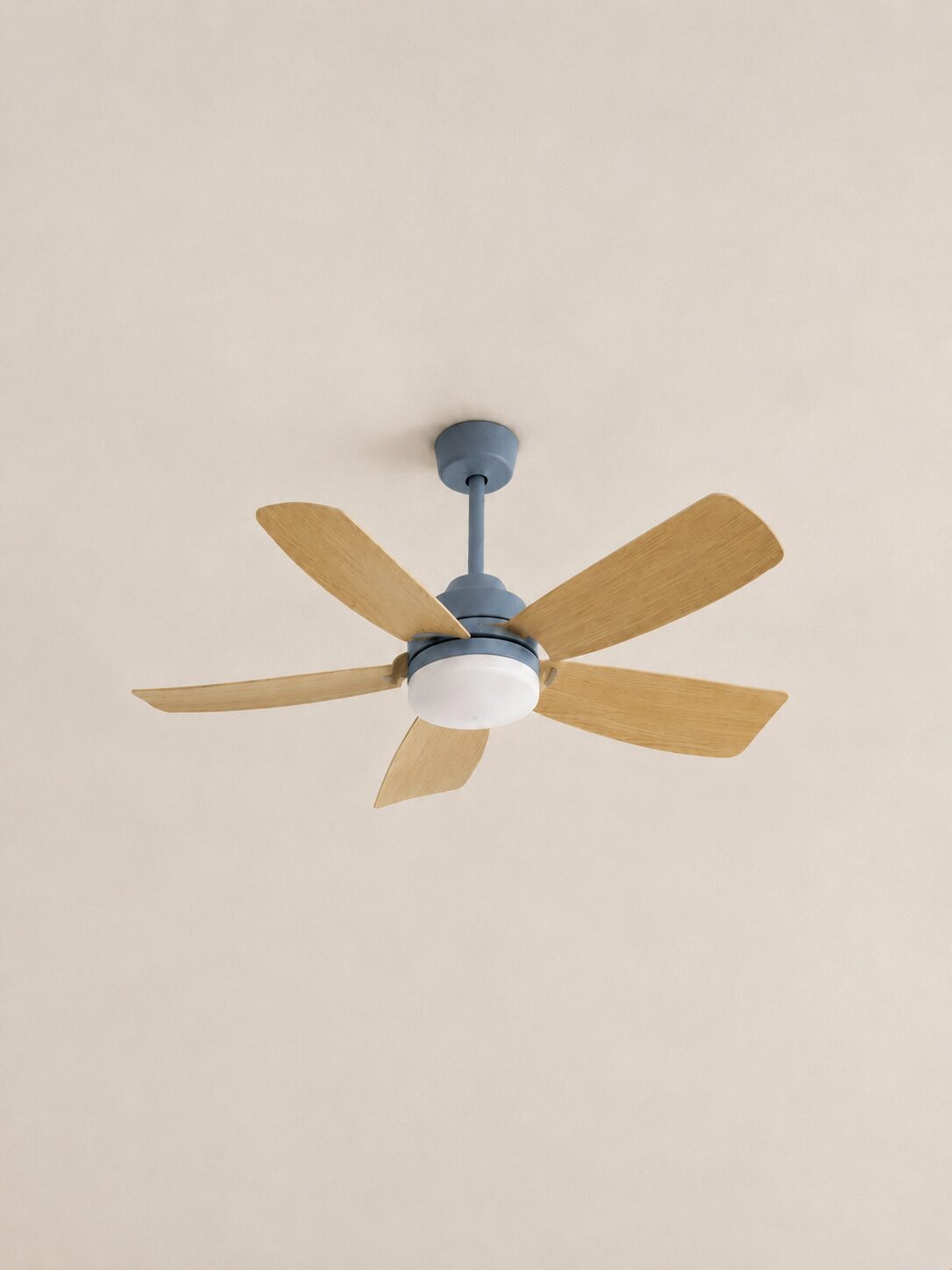 42-inch Wooden Color five-blade ceiling fan with integrated LED centered on a pale limewash ceiling